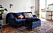 Persisk matta och monstera, blå Howard-soffa med fotpall. 