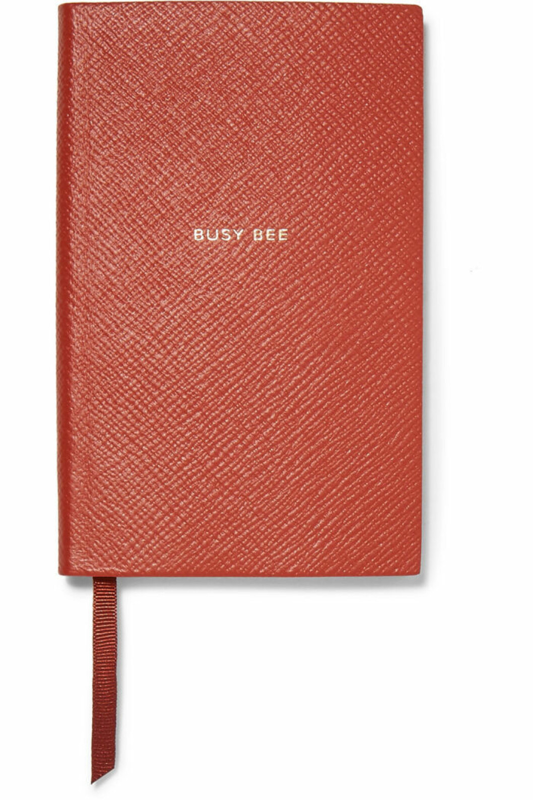 Stilfullt anteckningsblock från Smythson i en klassisk röd nyans med texten "Busy Bee".
