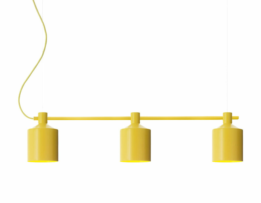 Gul taklampa med inspiration av en silo.