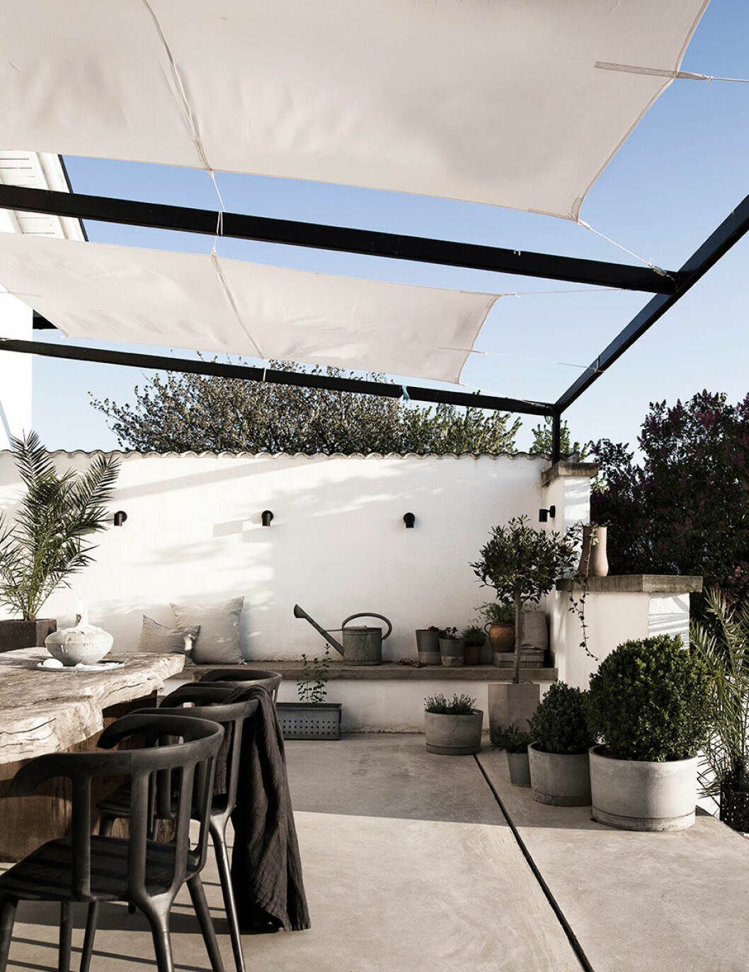 Syns i: <a href="https://www.elle.se/decoration/halsa-pa-i-var-bloggare-daniella-wittes-makalosa-hem/">”Kika in i Daniella Wittes makalösa hem”</a>. Foto och styling: Daniella Witte Uteplats med generöst matbord och spända vita tyger som tag mellan gedigna pelare
