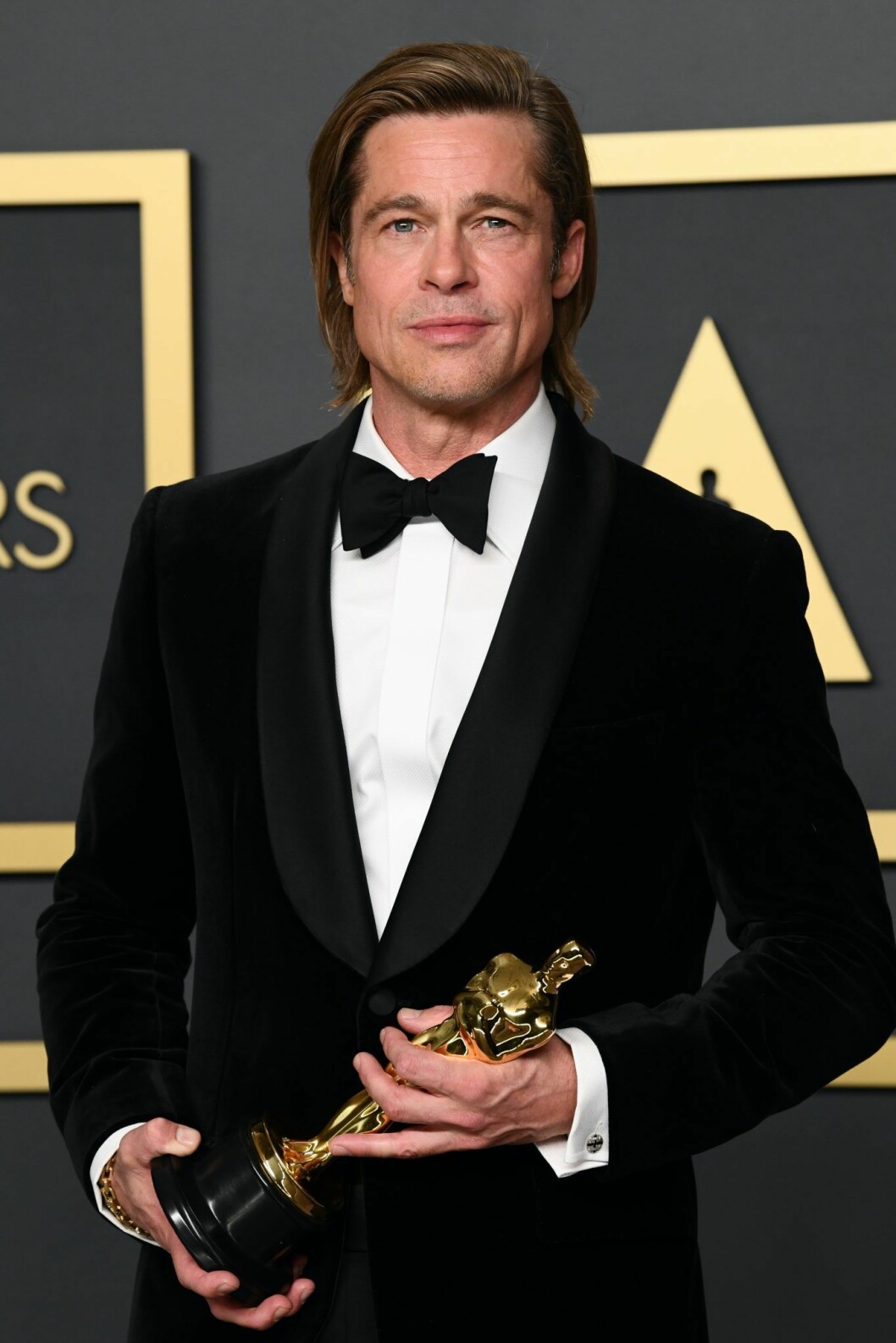 Brad Pitt I smoking håller i en statyett.