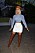Cardi B poserar i vit minikjol, croppad blazer och matchande stövlar och basker i West Hollywood, 2019.