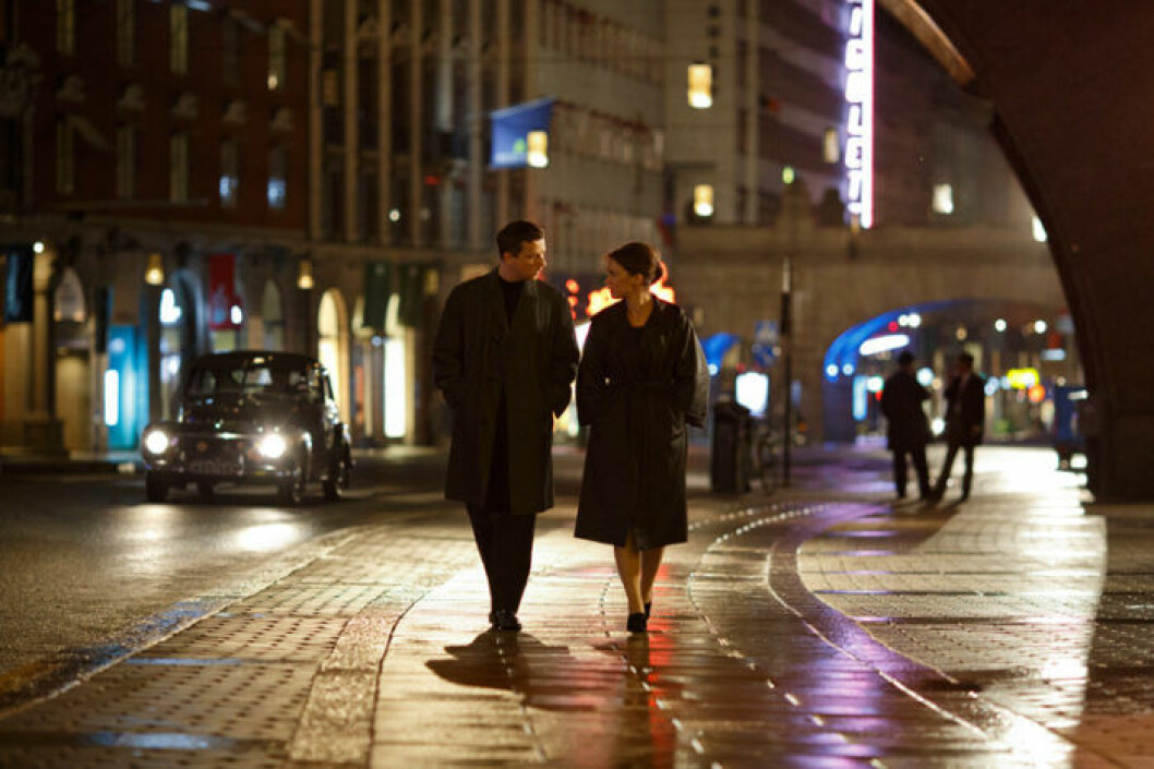 Calle Svensson (Charlie Gustafsson) och Nina Löwander (Hedda Stiernstedt) promenerar på Kungsgatan. Det är som bäddat för att en tidsdetektiv ska titta på Volvo PV:n för att avgöra årsmodell. Bild. Johan Paulin/SVT Calle och Hedda promenerar i Vår tid är nu