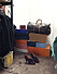 En del av parets walk–in closet med Louis Vuitton väska och färgglada skokartonger på hög