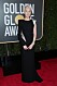 Saoirse Ronan bär en svart långklänning med skimrande silver detaljer.