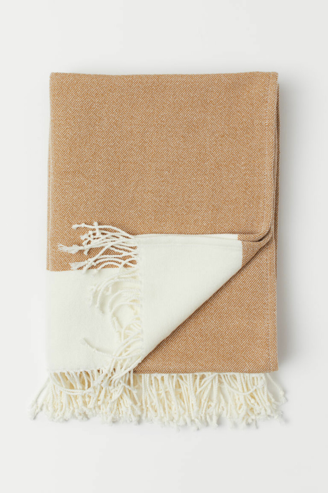 Beige pläd i virkad bomullsblandning, från H&M Home.
