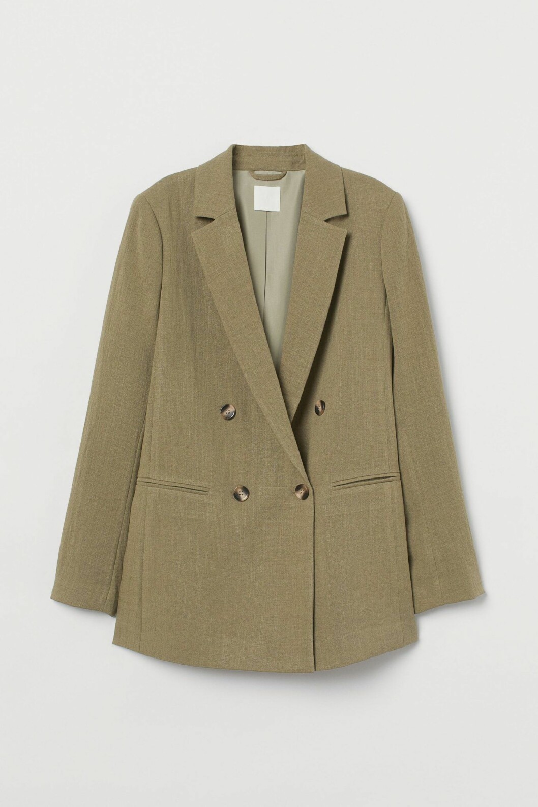 Beige kavaj från H&M som adderar en uppstyrd känsla.