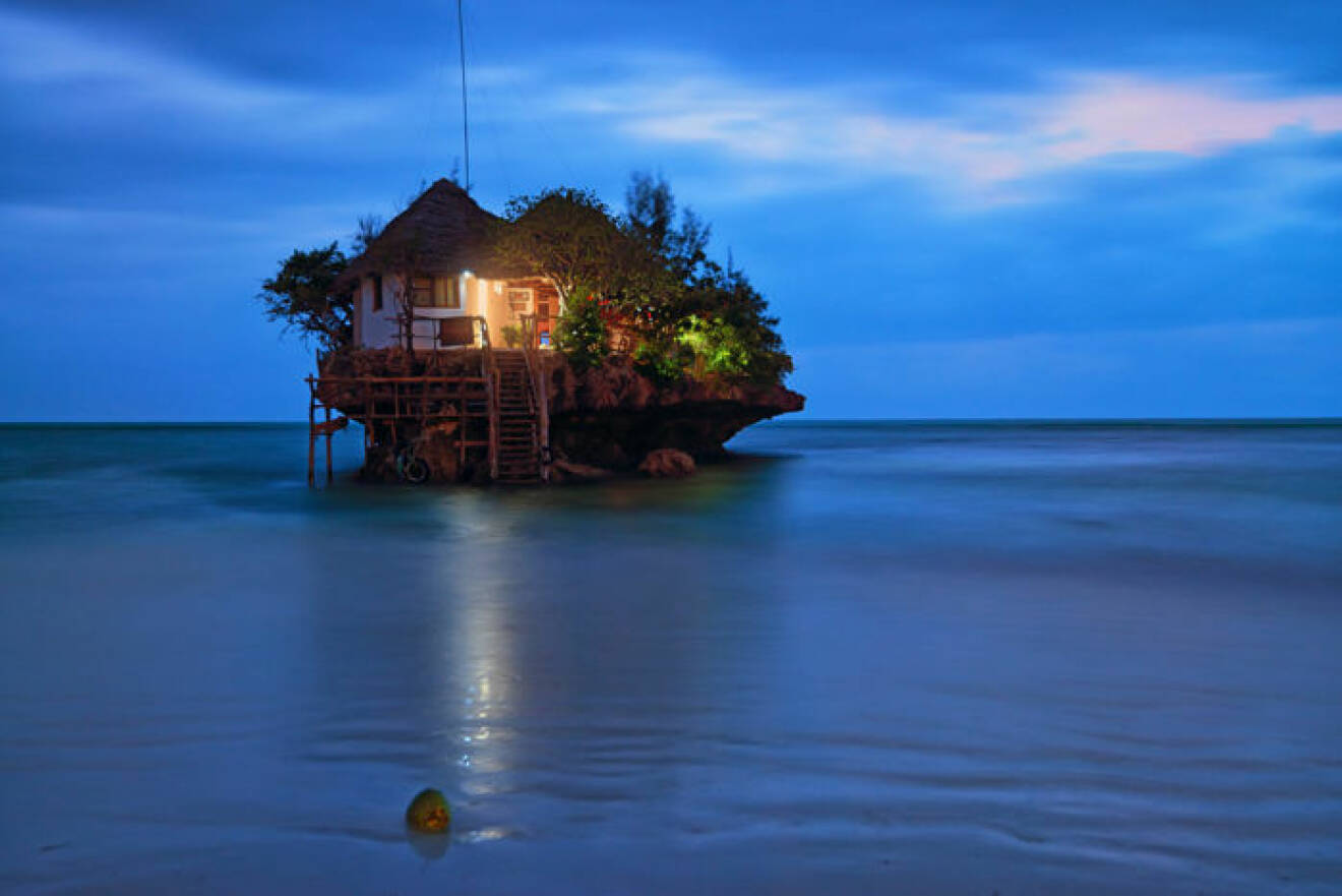Rock romantic restaurant in Indian ocean near Zanzibar coastline.