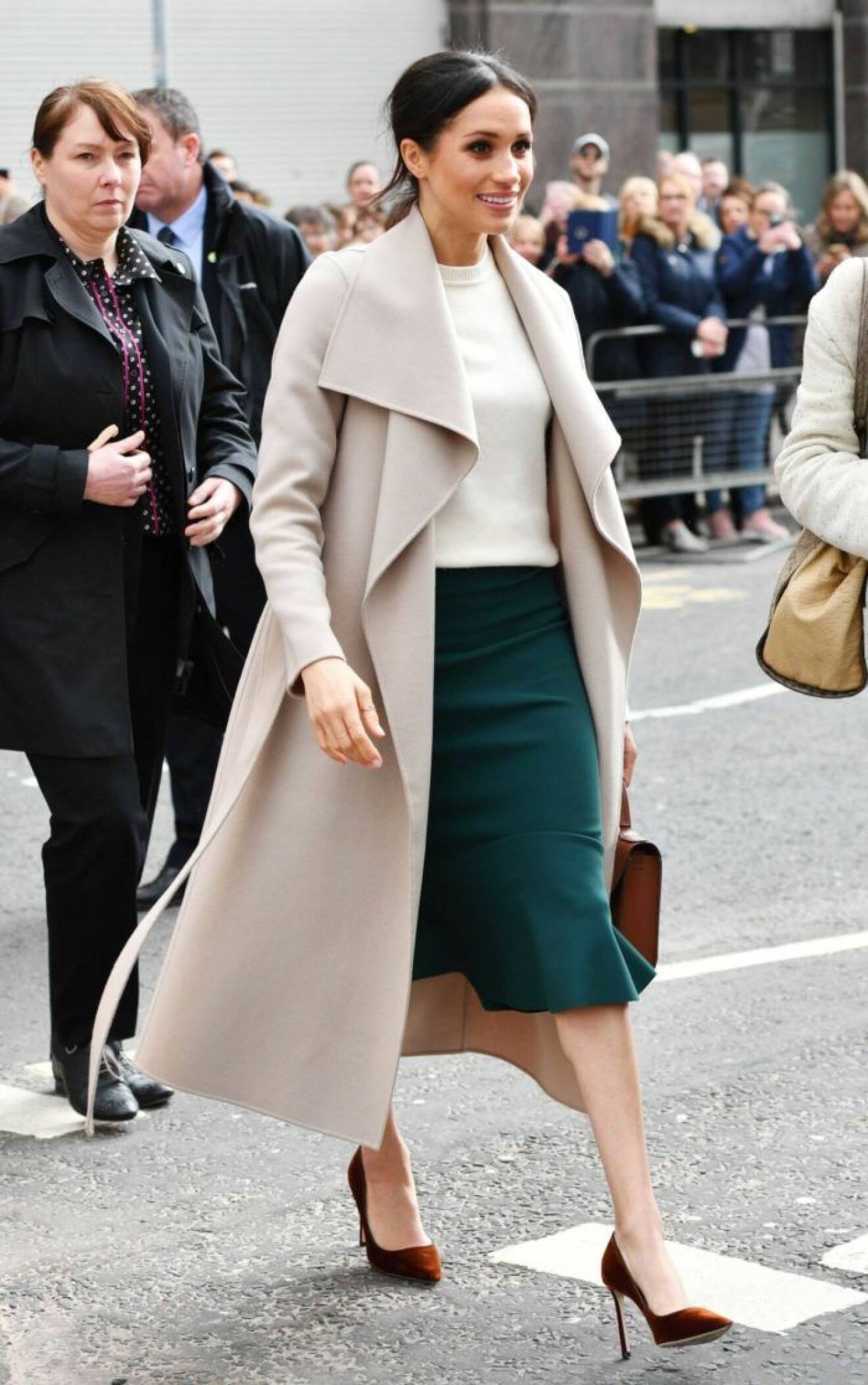 Meghan Markle i grön kjol, kashmirtröja från Victoria Beckham och ljus kappa