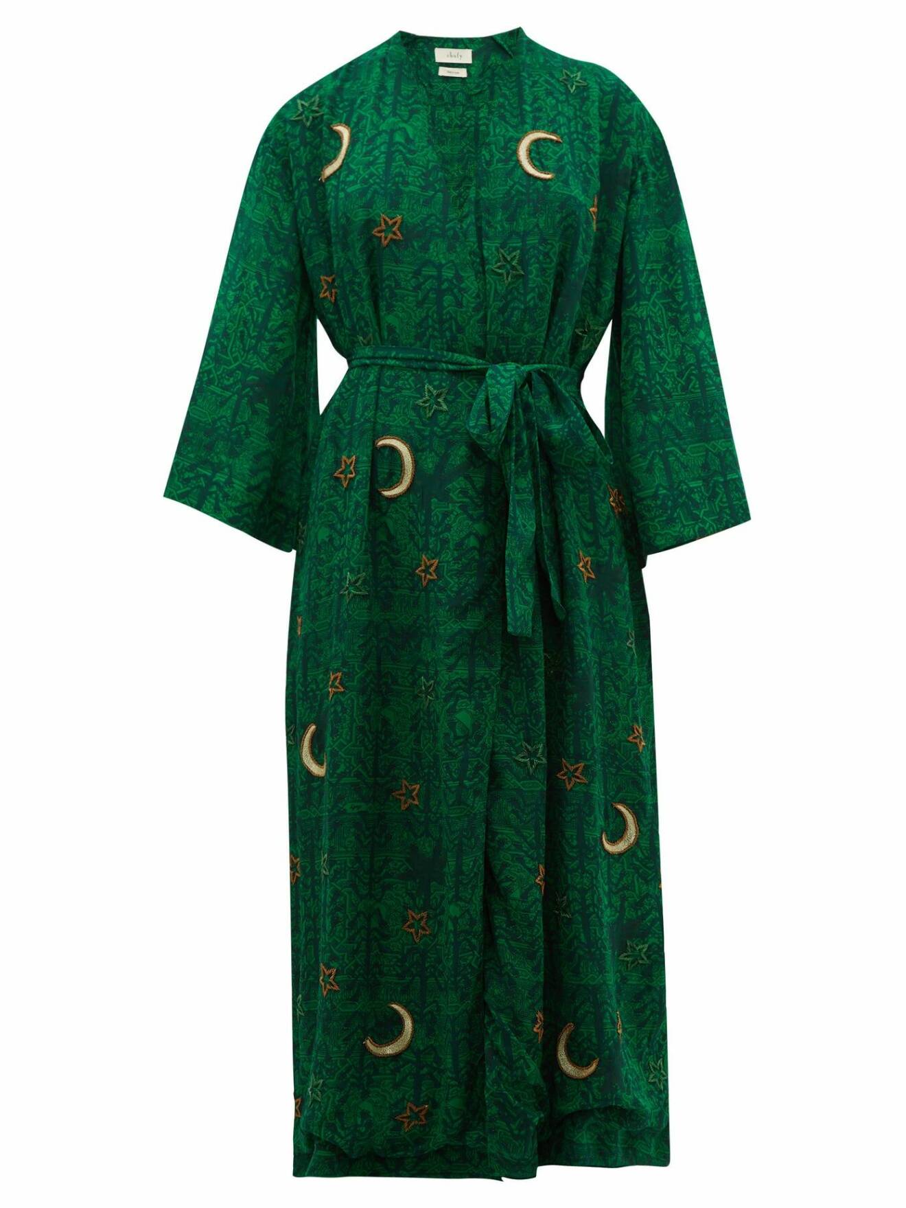 Mörkgrön elegant kaftan/morgonrock med astroinspirerade motiv av stjärnor och månar.
