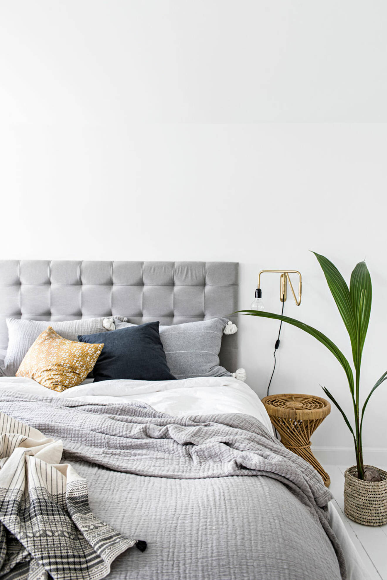 Nordiskt inrett sovrum med gråa toner och lätta nyanser av färg