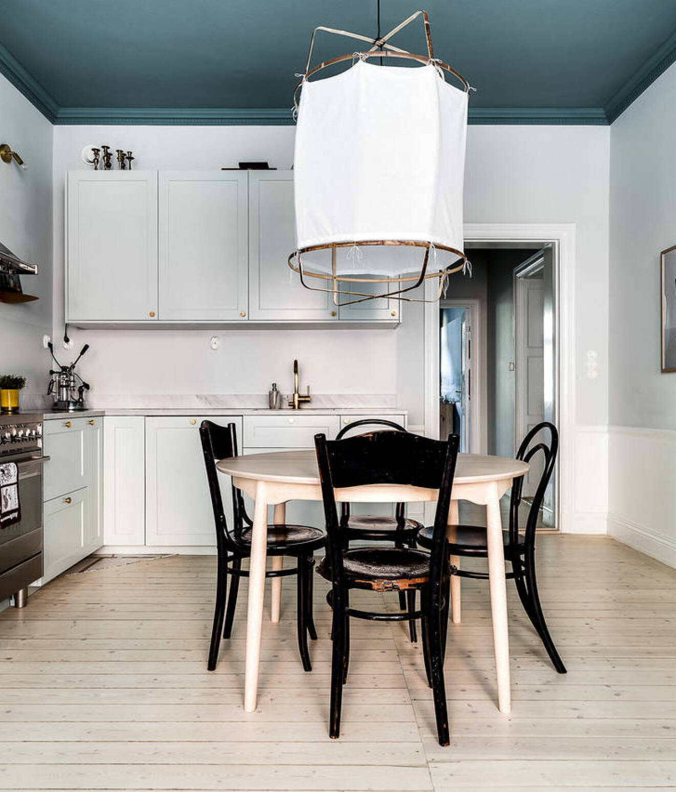 Blue painted ceiling in an apartment in Stockholm. Scandinavian styled kitchen. 