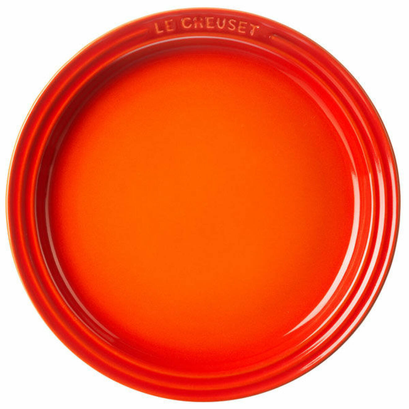 Le Creusets tallrik i eldigt orange.