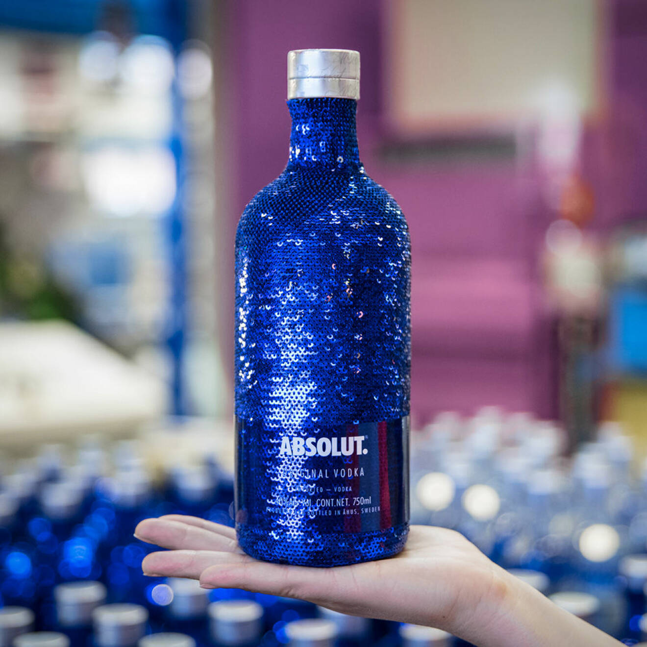 Flaskan är iklädd ett fodral av paljetter i silver och Absoluts blåa signumfärg.