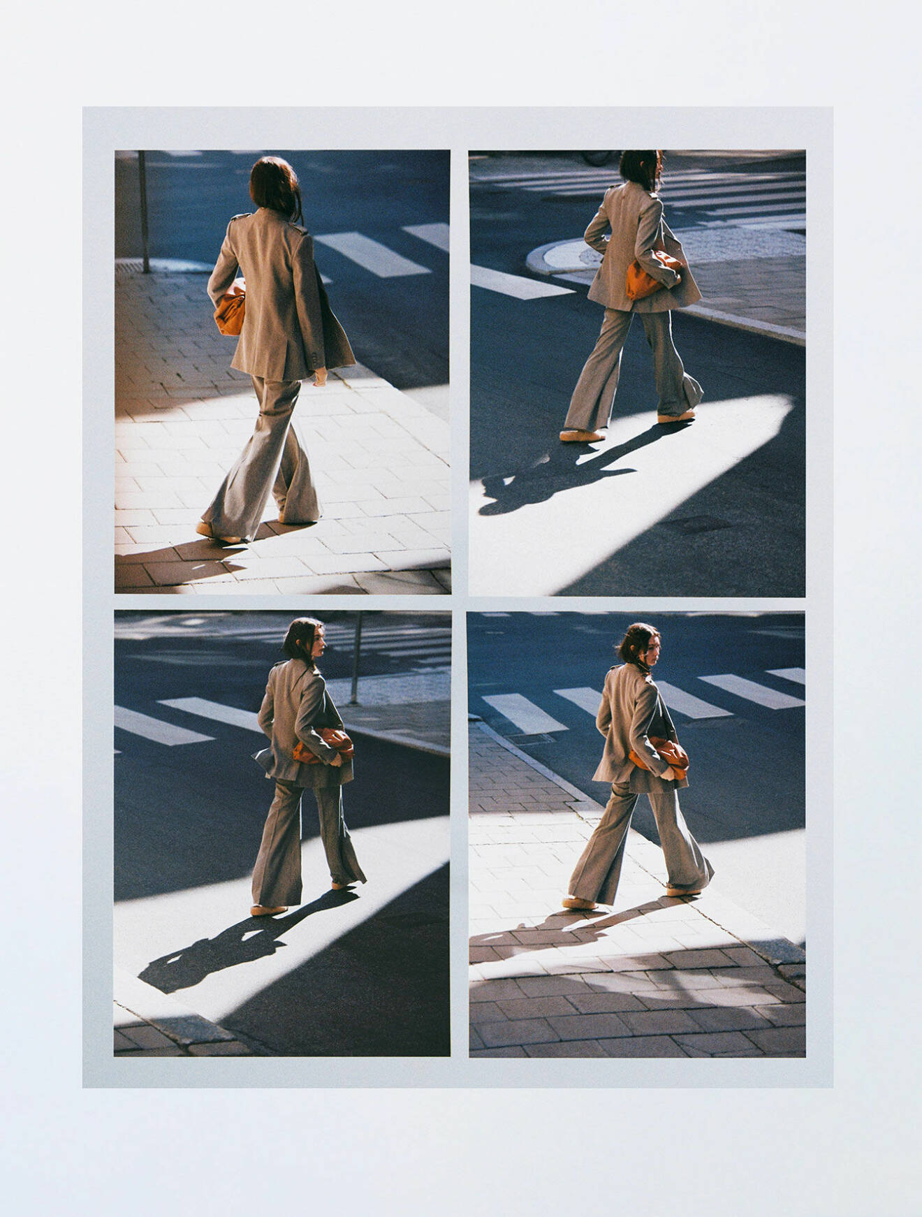 Modellen bär matchande grå kavaj och byxor från Chloé tillsammans med en orange handväska från Bottega Veneta