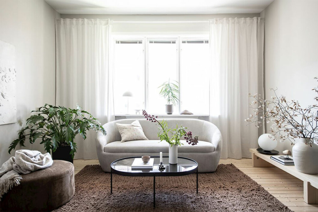 Skapa balans med möbler i rätt storlek. Foto: Maria Sahlander Styling: JosefssonLjung för Bjurfors/mäklare: Carolina Bäcklund Vardagsrum med soffa och sittpuff i beige och brunt