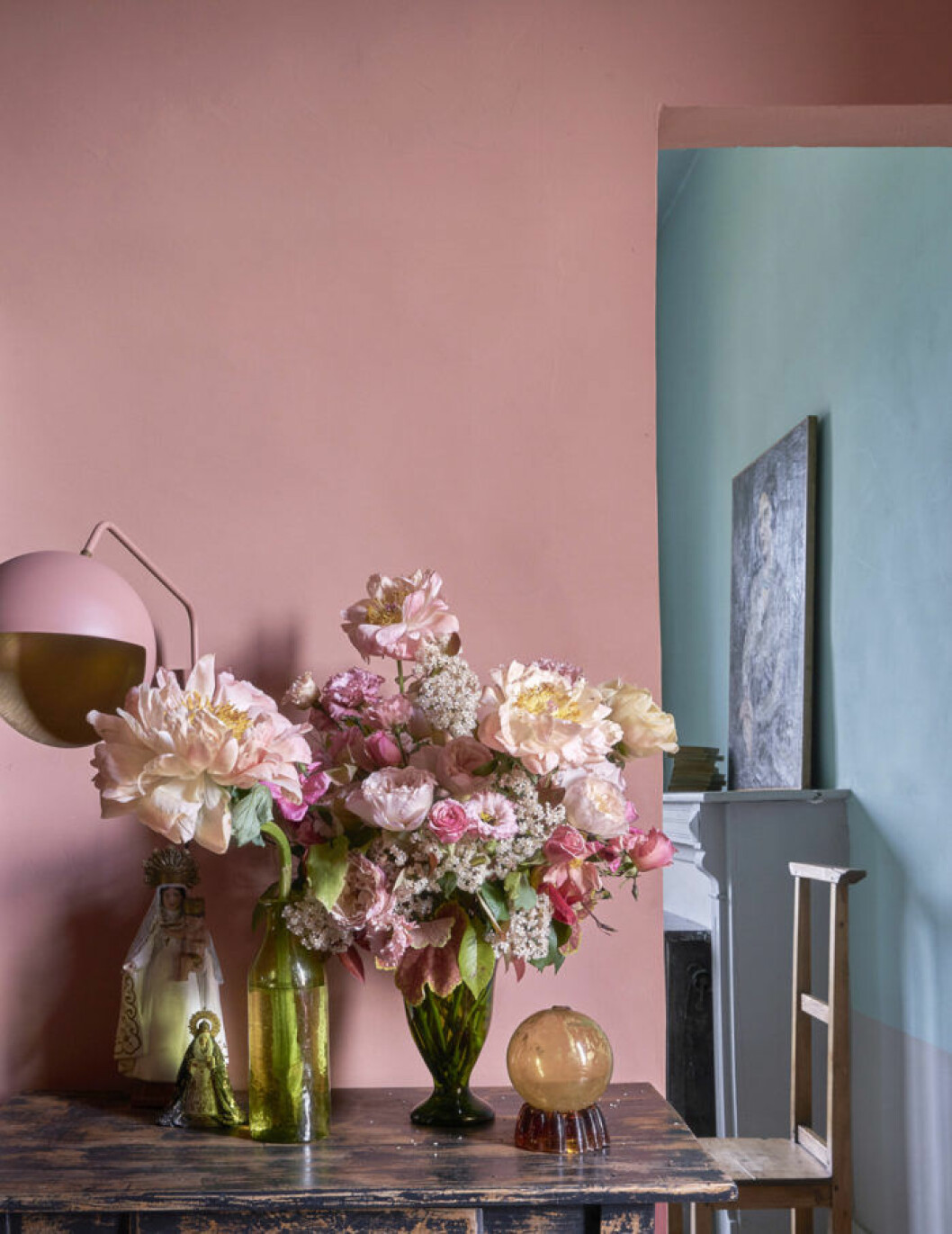 Rosa vägg, rosa bordslampa, stor bukett med rosa blommor