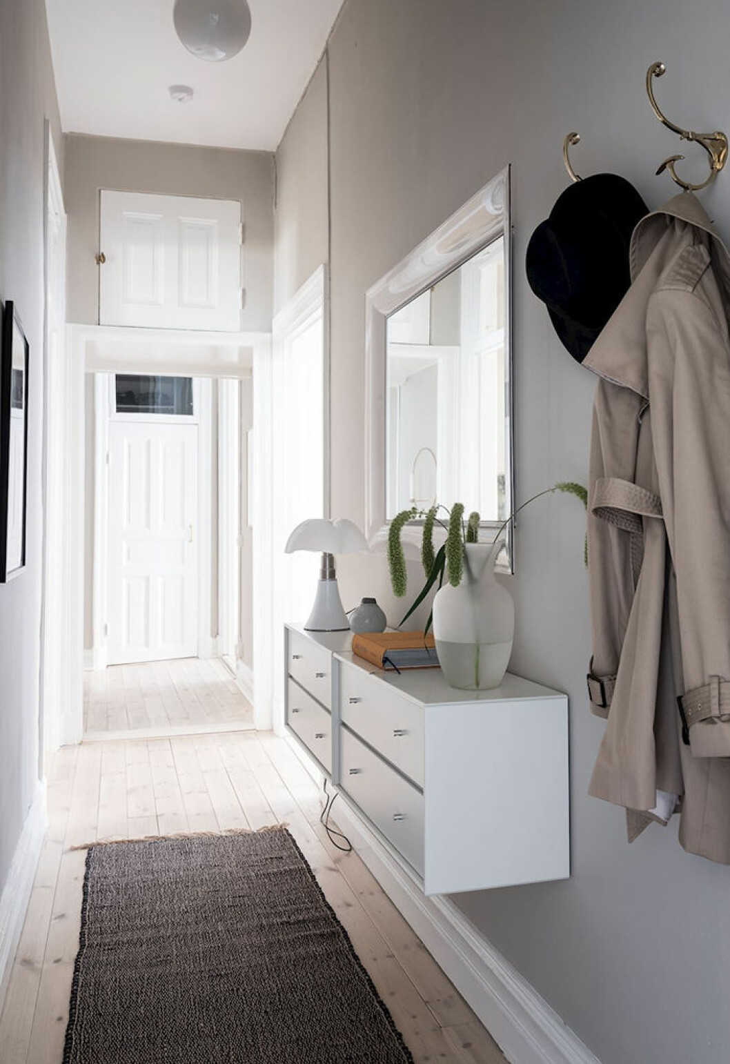 Lys upp i hallen med både tak- och bordslampa! Foto: Alen Cordic Styling: Nouvel för <a href="https://www.instagram.com/bjurfors_goteborg/?hl=sv" target="_blank" rel="noopener">Bjurfors</a>/mäklare: Charlotta Lenhammar Lättstädad och snygg hall med vägghängd förvaring