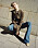 Modellen bär en rutig skjortblus från AWAKE Mode och jeans från Celine by Heidi Slimane