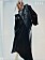 Fotomodellen bär en svart läderväst från Acne Studios tillsammans med en svart långklänning från By Malene Birger.