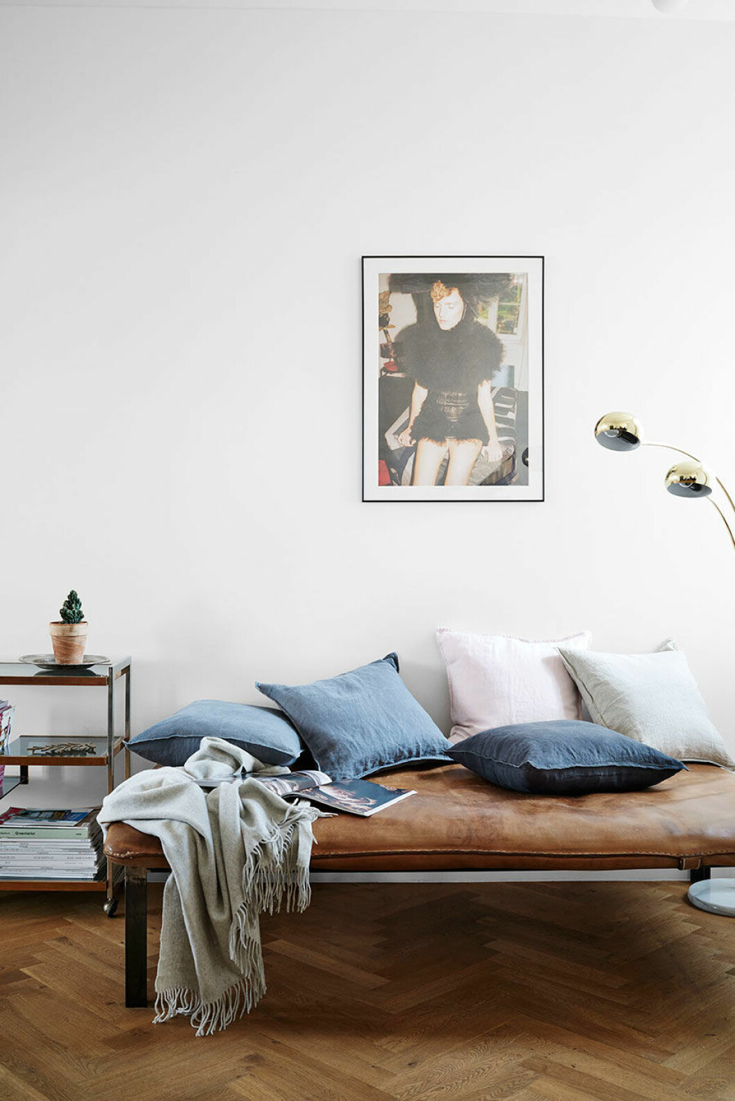 På dagbädden i väl patinerat läder ligger linnekuddar från H&M Home.