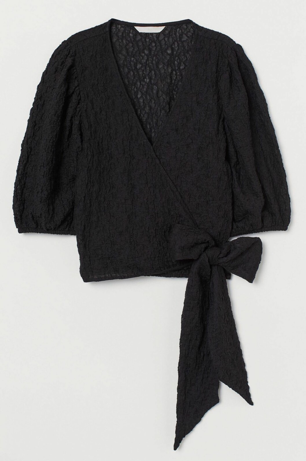 Svart blus med puffärm och rosettdetalj från H&M.