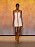 Kort klänning i beige med bruna skinndetaljer från Hermès.