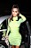 Kim Kardashian i en grön klänning med gult mönster.