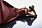 Fotomodellen ligger på golvet, hon har på sig en röd klänning från Chloé och svarta solglasögon från Acne Studios