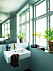 Badrummet går i ljusgröna toner med växter längs fönstret hemma hos Sofia Linfeldt i Skåne