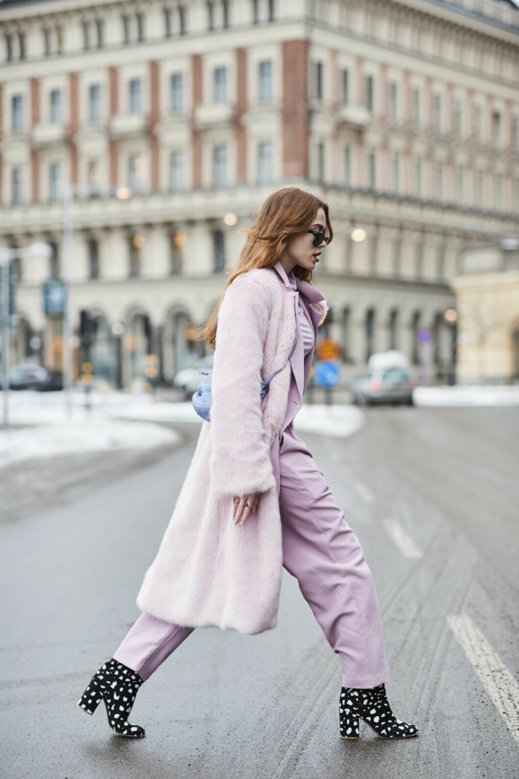 Kvinna i rosa outfit med prickiga skor