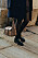 street style med svarta loafers med guldspänne, blå kappa och brun väska