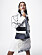 Modellen bär en vit jacka med svarta detaljer från Chloé, tillsammans med topp och en kjol med paljetter, båda från Jil Sander by Lucie and Luke Meier